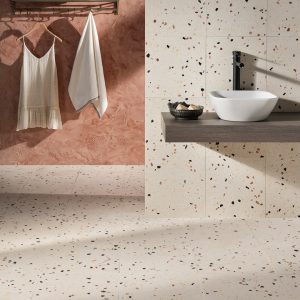 Terrazzo effect bathroom floor and walls in warm neutral tones.